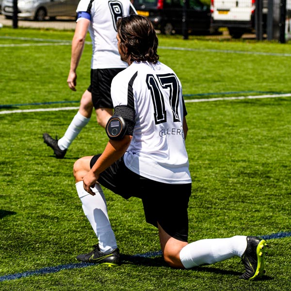 Man stretching before football game wearing CELLER8 on arm 