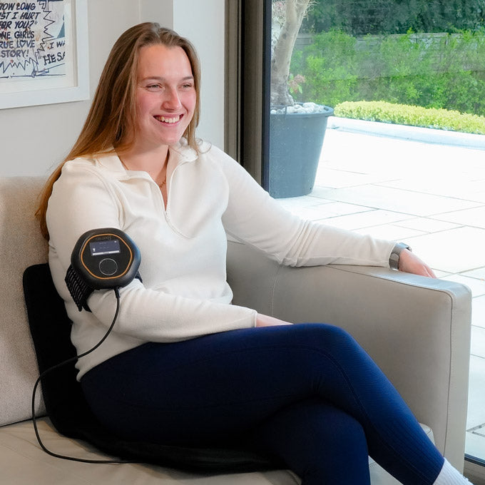 Sitting on travel mat on sofa while having CELLER8 applied to arm