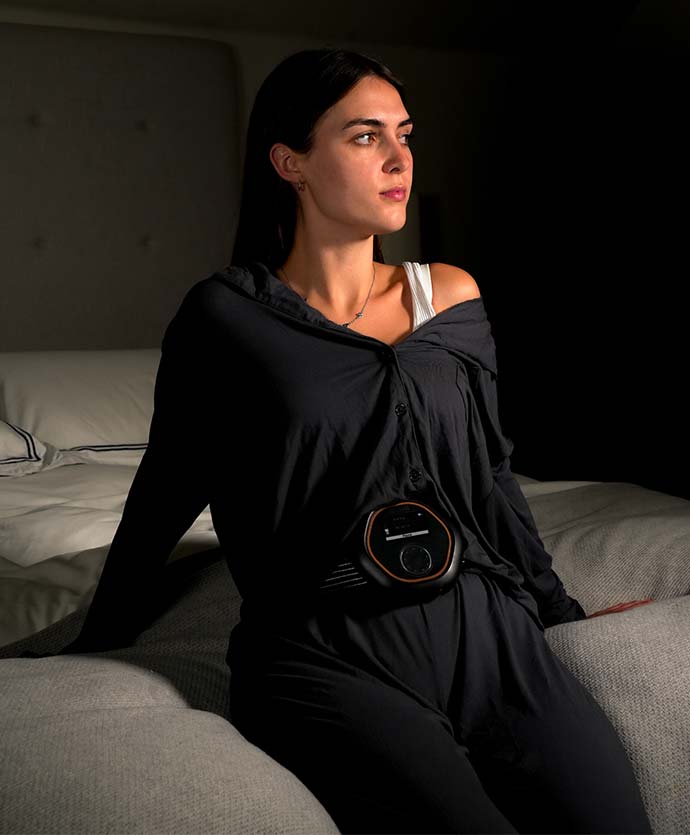 Women sat on edge of bed wearing CELLER8 around waist